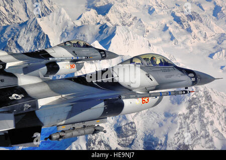 A pair of  F-16 Fighting Falcon Aggressors fly over the Alaska Range during RED FLAG-Alaska 10-2, April 20, 2010, Eielson Air Force Base, Alaska. RF-A provides participants 67,000 square miles of airspace, more than 30 threat simulators, one conventional bombing range and two tactical bombing ranges containing more than 400 different types of targets. The F-16s are assigned to the 18th Aggressor Squadron.  Staff Sgt. Christopher Boitz) Stock Photo