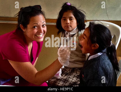 Capt. Hannah Diaz, a nurse-midwife from the 96th Surgical Operations Squadron, administers fluoride dental treatments to children during a free clinic. She was one of 14 military medical specialists on a mission trip called Healing Peru. The team provided free medical services, preventive health care and health education to the natives of Andahuaylillas, Peru. Stock Photo