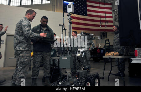 U.S. Air Force Maj. Gen. Richard Clark, the Eighth Air Force commander, center, is briefed by Airman 1st Class Roger McMurray, an Explosive Ordnance Disposal technician assigned to the 509th Civil Engineer Squadron, about equipment that is used during ordnance calls at Whiteman Air Force Base, Mo., Jan. 25, 2016. Clark operated one of the robotic ordnance units to see firsthand how they work.  Airman 1st Class Jovan Banks ) Stock Photo