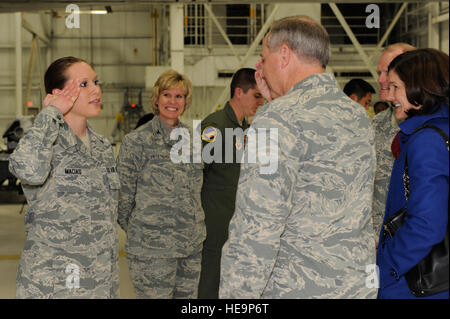 Senior Airman Kristina Macias, 28th Medical Operations Squadron public health technician, salutes Air Force Chief of Staff Gen. Mark A. Welsh III, after being recognized as a superior performer at Ellsworth Air Force Base, S.D., Nov. 26, 2013. Welsh met with Airmen to thank them for their service and discuss current Air Force challenges and opportunities.  Senior Airman Zachary Hada Stock Photo