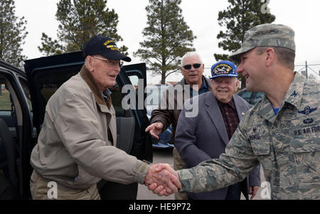 Retired Col. Hilary Cole, former Army Air Corps pilot, is greeted by Col. Gentry Boswell, 28th Bomb Wing commander, at Ellsworth Air Force Base, S.D., March 18, 2016. In his career, Cole flew over 65 missions in Europe as well as another nine with the Royal Air Force, earning 15 air medals in the process.  Airman Donald Knechtel Stock Photo