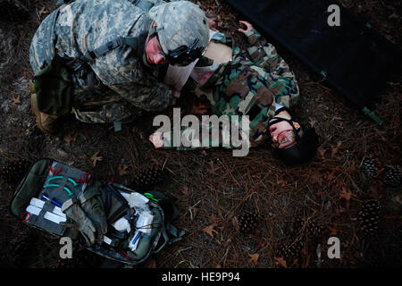 A. U.S. Soldier, a combat medic, assists a simulated aircraft crash victim during exercise Emerald Warrior at Hurlburt Field, Fla., March 7, 2012. Emerald Warrior is a training exercise for special operations forces, support personnel, conventional forces, interagency and nongovernmental organizations that trains them in urban and irregular warfare settings to support theater campaigns.  Tech. Sgt. Charles Larkin Sr. Stock Photo