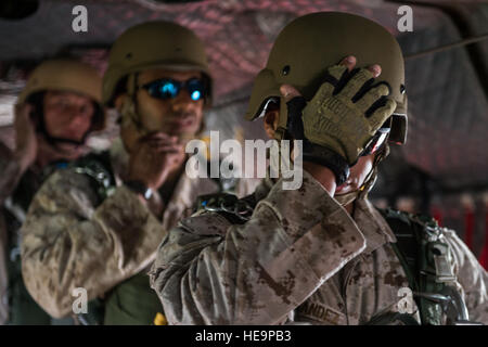 U.S. Marine Corps paratroopers with the 4th Air and Naval Gunfire Liaison Company, the 3rd Force Reconnaissance Company and the 4th Reconnaissance Battalion prepare for a jump from an Army CH-47 Chinook helicopter over the John C. Stennis Space Center in Mississippi May 7, 2014, during Emerald Warrior 14. Emerald Warrior is a U.S. Special Operations Command-sponsored two-week joint/combined tactical exercise designed to provide realistic military training in an urban setting.  Senior Airman Jodi Martinez Stock Photo