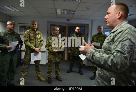 Master Sgt. Etienne Tousignant, 86th Force Support Squadron career assistance adviser, briefs a group of enlisted leaders from six different nations’ air forces throughout Europe about the professional enhancement center and First Term Airman Center at Ramstein Air Base, Germany, Feb. 23, 2015. The group of enlisted leaders included the chief master sergeant of the Romanian and Estonian air forces and other leaders from the German, Italian, Slovenian and the United Kingdom’s air forces visited Ramstein before attending the Kaiserslautern Military Community First Sergeant Council's First Sergea Stock Photo