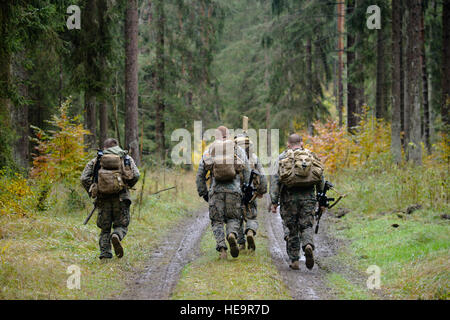 U.S. Marines run to their next challenge during the European Best Sniper Squad Competition at the 7th Army Training Command’s, Grafenwoehr Training Area, Bavaria, Germany, Oct. 25, 2016. The European Best Sniper Squad Competition is an Army Europe competition challenging militaries from across Europe to compete and enhance teamwork with Allies and partner nations.  Spc. Emily Houdershieldt) Stock Photo