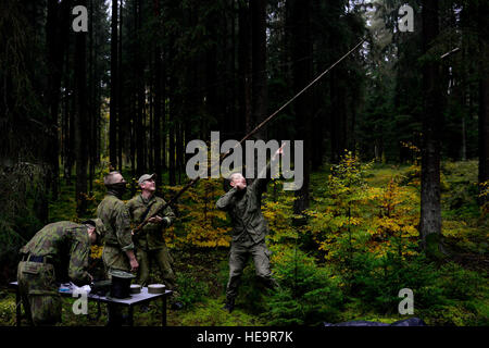 Lithuanian soldiers construct a Field Expedient Antenna as part of the European Best Sniper Squad Competition at the 7th Army Training Command’s, Grafenwoehr Training Area, Bavaria, Germany, Oct. 25, 2016. The European Best Sniper Squad Competition is an Army Europe competition challenging militaries from across Europe to compete and enhance teamwork with Allies and partner nations.  Spc. Emily Houdershieldt) Stock Photo