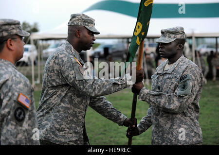 GUANTANAMO BAY, Cuba – Army Lt. Col. Alexander Conyers (left), 525th Military Police Battalion commander, passes the 193rd Military Police Company guidon to Army Capt. Nick Francois, during a change of command. Capt. Francois assumed command of the 193rd Military Police Company at Joint Task Force Guantanamo during a ceremony at Bulkeley Field June 4, 2010. The 193rd Military Police Company is responsible for a portion of the guard duties at JTF Guantanamo. JTF Guantanamo conducts safe, humane, legal and transparent care and custody of detainees, including those convicted by military commissio Stock Photo