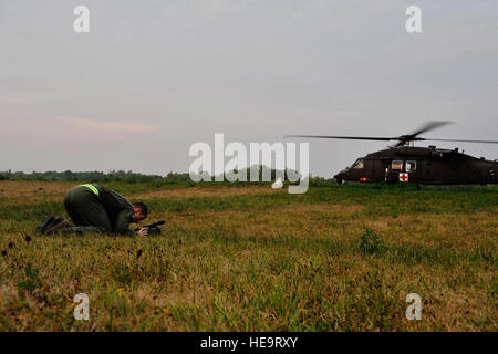 U.S. Air Force Staff Sgt. Robert Aten, 1st Combat Camera Squadron, documents a U.S. Army aircrew from the 7th Battalion, 158th Aviation Regiment as they conduct pre-flight checks aboard a UH-60 Blackhawk in order to be ready to leave at a moment's notice for a medical evacuation mission during Exercise Vibrant Response at Camp Atterbury, Ind., Aug. 19, 2011.  Vibrant Response is the largest chemical, biological, radiological and nuclear (CBRN) response exercise designed to prepare expeditionary units focused on responding to domestic CBRN incidents.  (U.S. Air Force Photo Staff Sgt. Eric Harri Stock Photo