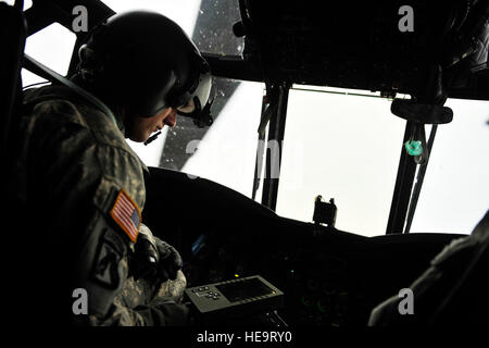 U.S. Army Warrant Officer Travis Wilson, 5th Battalion, 159th Aviation Regiment, conducts shut down procedures aboard a CH-47 Chinook after an aerial reconnaissance mission during Exercise Vibrant Response at Camp Atterbury, Ind., Aug. 19, 2011.  Vibrant Response is the largest chemical, biological, radiological and nuclear (CBRN) response exercise designed to prepare expeditionary units focused on responding to domestic CBRN incidents.  (U.S. Air Force Photo Staff Sgt. Eric Harris) Stock Photo