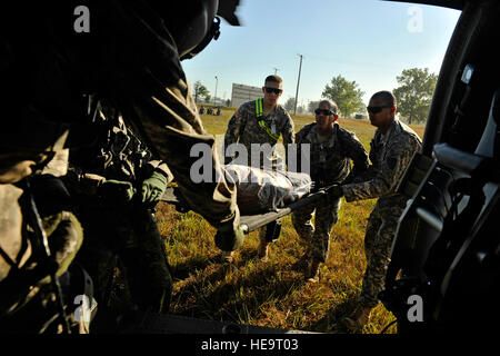 U.S. Army Soldiers load a patient onto a UH-60 Blackhawk from the 7th Battalion, 158th Aviation Regiment during Exercise Vibrant Response at Camp Atterbury, Ind., Aug. 22, 2011.  Vibrant Response is the largest chemical, biological, radiological and nuclear (CBRN) response exercise designed to prepare expeditionary units focused on responding to domestic CBRN incidents.  (U.S. Air Force Photo Staff Sgt. Eric Harris) Stock Photo