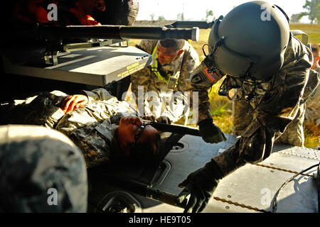 U.S. Army Sgt. Jake Vaughn, 7th Battalion, 158th Aviation Regiment, loads casualty aboard a UH-60 Blackhawk during a medical evacuation mission as part of Exercise Vibrant Response at Camp Atterbury, Ind., Aug. 22, 2011.  Vibrant Response is the largest chemical, biological, radiological and nuclear (CBRN) response exercise designed to prepare expeditionary units focused on responding to domestic CBRN incidents.  (U.S. Air Force Photo Staff Sgt. Eric Harris) Stock Photo