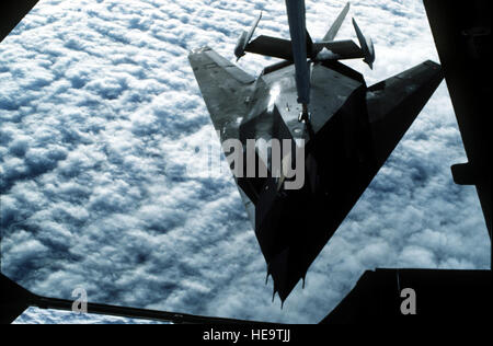 A 37th Tactical Fighter Wing F-117A stealth fighter aircraft refuels from a 22nd Air Refueling Wing KC-10 Extender aircraft during Operation Desert Shield.  The F-117A is en route to Saudi Arabia. Stock Photo