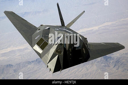 A U.S. Air Force F-117A 'Nighthawk' Stealth Fighter aircraft flies over Nellis Air Force Base, Nev., during the joint service experimentation process dubbed Millennium Challenge 2002. Sponsored by the US Joint Forces Command, the Millenniun Challenge 2002 experiment explores how Effects Based Operations can provide an integrated joint context for conducting rapid, decisive operations.   Staff Sgt. Aaron Allmon II) (Released) Stock Photo