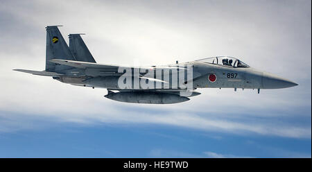 A Japanese Air Self-Defense Force F-15 Eagle fighter jet flies alongside a U.S. Air Force KC-135 Stratotanker refueling aircraft while waiting to be refueled on Okinawa, Japan, May 10, 2012. By training with the JASDF, the bilateral capabilities between the U.S. and Japan continue to be refined and enhanced when it comes to controlling the skies. Airman 1st Class Brooke P. Beers) Stock Photo