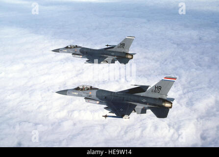 Air to air left side view of two United States Air Force Europe (USAFE) F-16 Fighting Falcons assigned to the 50th Tactical Fighter Wing, Hahn Air Base, Germany. Exact Date Shot Unknown. Stock Photo