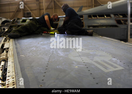 U.S. Air Force civilians Lonnie Thomas and Andrew Bakios, 567th Aerospace Maintenance and Regeneration Squadron perform maintenance on one of six fuel tanks on the QF-16 at the 309th Aerospace Maintenance and Regeneration Group at Davis-Monthan Air Force Base, Ariz., July 9, 2013. The 'Q' designation in the aircraft's name signifies that the aircraft is a drone.  Senior Airman Christine Griffiths Stock Photo