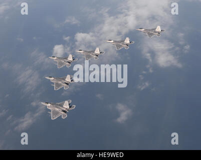 Six  F-22 Raptors from the 95th Fighter Squadron from Tyndall Air Force Base, Fla., fly over the Gulf of Mexico Nov. 5 during a local training mission.  The group of six  F-22s  were part of a large group formation of 15 Raptors.  Tech. Sgt. Burt Traynor Stock Photo