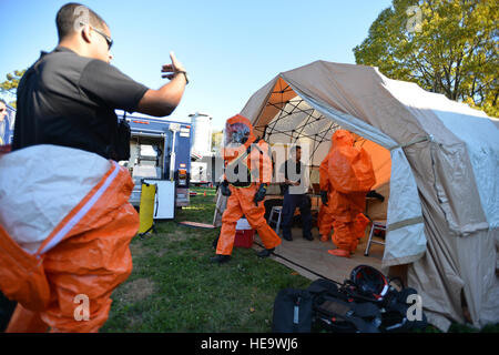 Members of the New York National Guard's 24th Weapons of Mass Destruction Civil Support Team (CST) exit  the decontamination tent during a drill at the Suffolk County Water Authority's  New Highway Pump Station on Monday, Oct. 27, 2014. National Guard CSTs are trained to identify the presence of chemical, biological, or radiological agents and provide that information to local authorities. The exercise tested response protocols to intruder events and to identify and correct any existing weaknesses in station security.(U.S. Air National Guard by Senior Airman Christopher S Muncy / released) Stock Photo