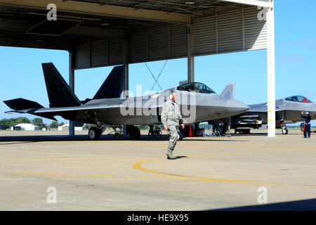 An F-22 Raptor from the 94th Fighter Squadron taxis onto the flight line during an exercise at Langley Air Force Base, Va., Oct. 16, 2014. The exercise was piloted by the 1st and 192nd Fighter Wings, and tested wing members’ ability to efficiently launch and retrieve aircraft.  Airman 1st Class Areca T. Wilson Stock Photo