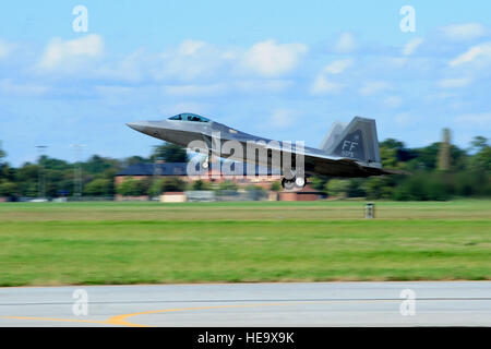 An F-22 Raptor from the 94th Fighter Squadron takes off during an exercise at Langley Air Force Base, Va., Oct. 16, 2014. The exercise evaluated the proficiency of members assigned to the 1st and 192nd Fighter Wings to be able to launch and retrieve aircraft.  Airman 1st Class Areca T. Wilson Stock Photo