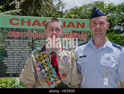 Troop 1420 Boy Scout Jackson Umlauf and his father Maj. Kurt Umlauf, 36th Munitions Squadron operations officer, stand in front of a memorial sign listing the names of the men lost in the Chagui'an Massacre in the village of Yigo, Guam, on July 14, 2014. The Umlaufs brought together the 36th MUNS and Boy Scouts of America Troop 1420 to update the forgotten memorial site.  Senior Airman Katrina M. Brisbin Stock Photo