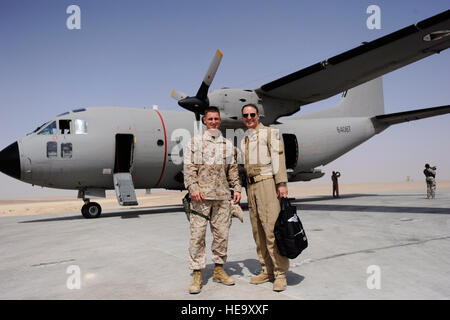 Marine First Lt. Benjamin Boera, (left) 5th Battalion 11th Marines High Mobility Artillery Rocket System Tango Battery platoon commander, and his dad, Brig. Gen. Michael Boera, 438th Air Expeditionary Wing and Combined Air Power Transition Force commander, pose for a photo in front of a C-27A Spartan cargo plane the general was flying March 28, at Camp Bastian, Afghanistan. Stock Photo