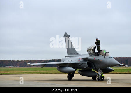 A French air force (FrAF) pilot exits a Rafale prior to the inaugural Trilateral Exercise, at Langley Air Force Base, Va., Dec. 1, 2015. The FrAF Rafales, U.S. Air Force F-22 Raptors and British Royal Air Force Typhoons will participate in a variety of scenarios taking place over water during daylight hours.  Senior Airman Aubrey White) Stock Photo