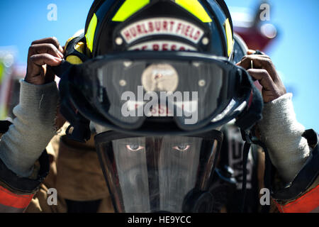 Airman 1st Class Keith Fussell dons his helmet before training July 17, 2014, at Hurlburt Field, Fla. Firefighters spent more than an hour training on the correct ventilation techniques to maintain proper readiness to complete the mission. Fussell is a 1st Special Operations Civil Engineer Squadron firefighter. Senior Airman Christopher Callaway) Stock Photo