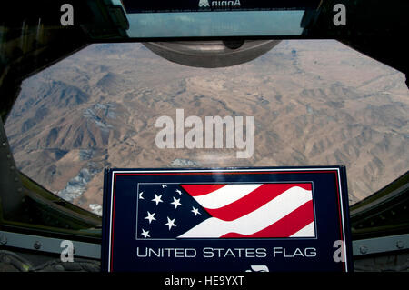 An American flag is flown over Afghanistan in a KC-135 Stratotanker on a combat support mission Nov. 2, 2013. Flying flags in a combat zone is a tradition that honors the service of men and women in uniform and symbolizes their efforts in maintaining freedom. Staff Sgt. Robert Barnett) Stock Photo