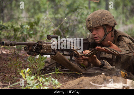 A U.S. Army Ranger student, assigned to the Airborne and Ranger Training Brigade, fires an M240 Bravo machine gun in a fighting position at a patrol base on Camp Rudder, Eglin Air Force Base, Fl., July 8, 2016. The Florida Phase of Ranger School is the third and final phase that these Ranger students must complete to earn the coveted Ranger Tab.  Sgt. Austin Berner Stock Photo