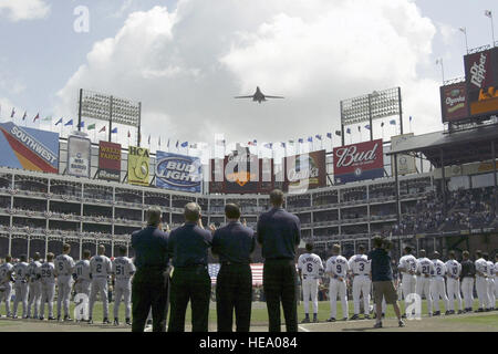 A US Air Force (USAF) B-1B Lancer Bomber from the 28th Bomb Squadron (BS), at Dyess Air Force Base (AFB), performs a low-level fly over the Texas Rangers during their first season home game, at their ballpark in Arlington, Texas. Stock Photo