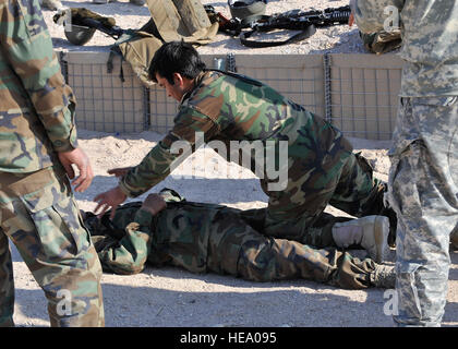An Afghan national army soldier demonstrates rescue procedures during the Afghan national security forces legion academy at Forward Operating Base Ramrod, Afghanistan, Dec. 15, 2009. The purpose of the academy is to train ANSF various field tactics to support their day-to-day operations.  Staff Sgt. Dayton Mitchell Stock Photo