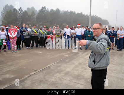 Col. Michael Harvey, Operation Toy Drop ground operations officer in charge assigned to U.S. Army Civil Affairs and Psychological Operations Command (Airborne), thanks Fort Bragg Airmen and Soldiers who participated in the Air Force’s annual Operation Toy Trot 5K race here Dec. 3. The event raised toys for the annual Randy Oler Memorial Operation Toy Drop scheduled for Dec. 5-7. Over 150 service members dressed in holiday and fitness attire, donated toys and competed in the 5K race around the Pope Field flight line to help kickoff this year’s U.S. Army Civil Affairs and Psychological Operation Stock Photo