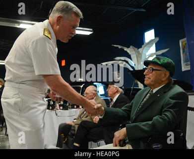 Vice Adm. Mark Fox, U.S. Central Command deputy commander, shakes the hand of former Army Pfc. Philip Melici, French Legion D'Honneur recipient, at a French National Day celebration in Tampa, Florida, July 14, 2014. Melici served for 23 months in England, France, Belgium and Holland as a pipeline patrolman during World War II.  Airman 1st Class Ned T. Johnston Stock Photo