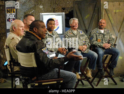 BAGRAM AIR FIELD, Afghanistan -- (From left to right) Curt Menefee, Terry Bradshaw, Howie Long, Michael Strahan, Jimmy Johnson, and Jay Glazer listen to questions during the pregame Nov. 7, 2009. The “Fox NFL Sunday” team came to visit Bagram to boost morale.  They are scheduled to broadcast live Nov. 8, 2009 from here.  Senior Airman Felicia Juenke) Stock Photo