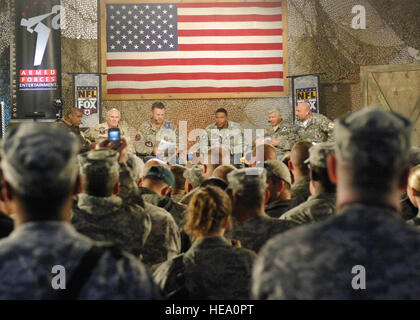 BAGRAM AIR FIELD, Afghanistan -- The crowd snaps photos during the “Fox NFL Sunday” pregame Nov. 7, 2009. (From left to right) Curt Menefee, Terry Bradshaw, Howie Long, Michael Strahan, Jimmy Johnson, and Jay Glazer came to visit Bagram to boost morale.  The “Fox NFL Sunday” team is scheduled to broadcast live Nov. 8, 2009 from here.  Senior Airman Felicia Juenke) Stock Photo