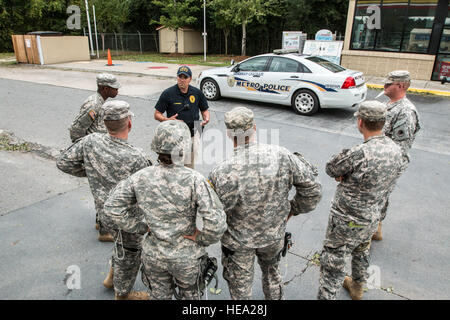 Citizen Soldiers of the 178th Military Police Company based in Monroe receive a brief from Sergeant  Max Nowinsky, West Chatham Precinct, Savannah Chatham Metropolitan Police prior to starting their patrol.  The MPs are patrolling the streets throughout the night to deter looting and to help stranded motorists. Stock Photo