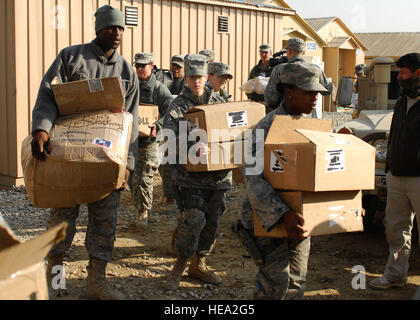 Airmen, from the 455th Air Expeditionary Wing, deliver boxes of toys, shoes, food, blankets, wool socks and other necessities to local Afghan men and children at one of the hospitals on Bagram Airfield, Dec. 21. Airmen, Soldiers and Sailors participated in this humanitarian aid event. Stock Photo