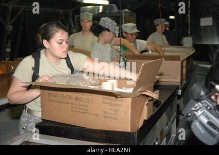 U.S. Army Spc. Isis Salgado unpacks rations at Fort Gordon, Ga., July 11. Salgado, assigned to the U.S. Army's 452nd Combat Support Hospital, Fort Snelling, Minn., helped assemble a field kitchen in support of Global Medic 2010. Global Medic is a joint field training exercise for Theater Aeromedical Evacuation System and ground medical components designed to replicate all aspects of combat medical service support allowing participating units to train as they fight. The exercise involves reserve units from the U.S. Army Reserve and U.S. Air Force. Stock Photo