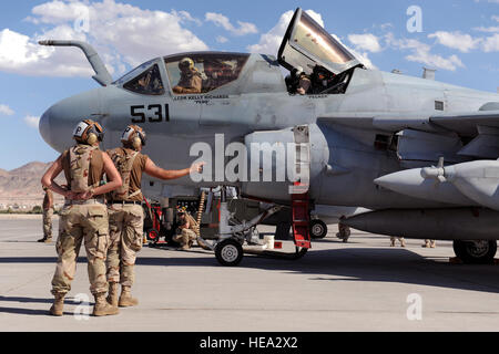 U.S. Navy Airman Fabian Lopez, a flight captain from Electronic Attack Squadron 133 out of Naval Air Station Whidbey Island, Wash., prepares to signal to Lt. Cmdr. Kelly Richards to launch her EA-6B Prowler aircraft during a sortie for Red Flag 09-5 at Nellis Air Force Base, Nev., Aug. 24, 2009. Red Flag is a realistic air combat training exercise conducted over the 15,000-square-mile Nevada Test and Training Range north of Las Vegas.  Airman 1st Class Brett Clashman, U.S. Air Force Stock Photo