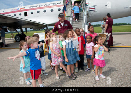 Maxwell AFB, Ala. - Following their tour of the famous C-54 'Spirit of Freedom' Skymaster Flying Museum, children enrolled in the Maxwell Child Development Center pose for a photo with C-54 Flight Chief Timothy Chopp on June 8, 2012. The Spirit of Freedom is on display as part of the 2012 Air Command & Staff College Gathering of Eagles. The Berlin Candy Bomber, Col. Gail S. Halvorsen, is one of 14 panelists chosen by ACSC students to further air space, cyberspace and leadership history. ( Melanie Rodgers Cox ** DD form 2830 on file for children. Stock Photo