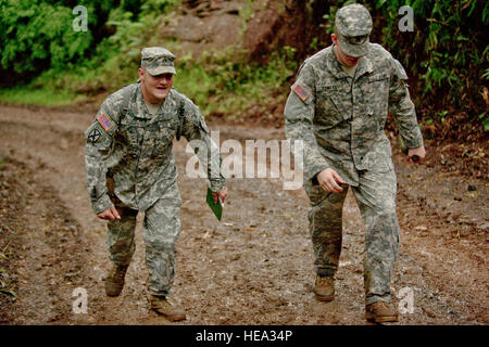 U.S. Army Sgt. Daniel Bowles and Sgt. Randal Busick, combat medics assigned to Schofield Barracks Health Clinic, walk up a muddy hill while tracking their first point during a five hour land navigation test as part of the 2012 Pacific Regional Medical Command Best Medic Competition Aug. 29, 2012, at Schofield Barracks, in Wahiawa, Hawaii. The PRMC Best Medic competition is a 72-hour physical and mental test of U.S. Army Medics leadership, teamwork, tactics, medical knowledge and warrior tasks. The winners of the PRMC competition move on to compete for the ArmyÕs Best Medic at Ft. Sam Houston i Stock Photo