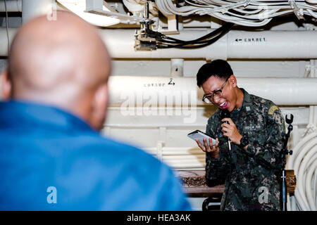 WATERS OUTSIDE OF OKINAWA (Aug. 12, 2016) Republic of Korea (ROK) Midshipman In Woo Song sings a song during Open Mic Night aboard the amphibious transport dock ship USS Green Bay (LPD 20). Green Bay, part of the Bonhomme Richard Expeditionary Strike Group, is operating in the U.S. 7th Fleet area of operations in support of security and stability in the Indo-Asia-Pacific region.  Mass Communication Specialist 1st Class Chris Williamson Stock Photo
