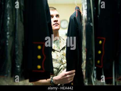 U.S. Marine Lance Corporal Adam Knebler, Marine liaison for uniforms section, hangs Marine service dress uniforms into inventory. The uniform section of the Charles C. Carson Center for Mortuary Affairs, Dover Air Force Base, Del., prepares uniforms for remains and works with military escorts for the dignified transfer of remains process.  /Staff Sgt. Bennie J. Davis III) Stock Photo