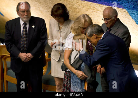 U.S. Air Force Maj. Gen. Darryll Wong, adjutant general of the Hawaii National Guard, comforts the daughter of fallen U.S. Marine Corps Master Sgt. Travis W. Riddick during the Hawaii State Medal of Honor ceremony March 27, 2013, held at the Hawaii State Capitol. This year, 19 fallen service members posthumously received the HMOH from the Hawaii State Senate and House of Representatives. ( U.S. Air Force Tech. Sgt. Michael R. Holzworth Stock Photo