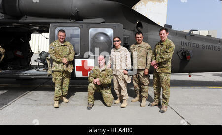 From left, retired Army Cpl. Steve Martin, Army Sgt. Tom Block, Medal of Honor recipient retired Marine Cpl. Kyle Carpenter, Medal of Honor recipient retired Army Master Sgt. Leroy Petry and retired Army Sgt. Ralph Cacciapaglia, pose in front of an HH-60 medical evacuation helicopter during a visit to the Dustoff ramp April 16, 2015 at Bagram Air Field, Afghanistan. The visit was conducted as part of Operation Proper Exit, a program developed to provide closure for service members severely injured in the line of duty.  Staff Sgt. Whitney Amstutz/released) Stock Photo