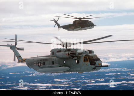 An air-to-air right side view of two 39th Aerospace Rescue and Recovery Wing HH-53 helicopters over Goose Bay while en route from Eglin Air Force Base, Florida, to Woodbridge, England. Stock Photo