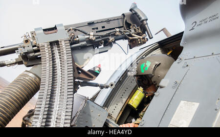 An aerial gunner with the 303rd Expeditionary Rescue Squadron looks out from his position over a training range in an HH-60 Pave Hawk during emergency procedures and daytime tactical flight maneuvers training after taking off from Camp Lemonnier, Djibouti, July 10, 2015. The 303rd ERQS conducts training flights to maintain proficiency and provide full mission capability to users while deployed in support of humanitarian aid and contingency operations in the Combined Joint Task Force Horn of Africa area of responsibility. ( Staff Sgt. Gregory Brook/ Released) Stock Photo