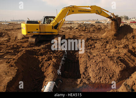 Northern Oil Company workers remove dirt to repair a broken gasoline pipeline near Riyahd village, Iraq, on February 13, 2007, restoring fuel delivery and pipeline integrity. Stock Photo