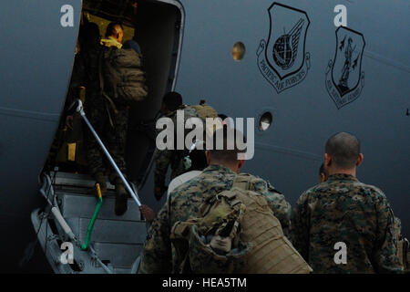 More than 50 Marines from the III Expeditionary Force at Marine Corps Air Station Futenma, Okinawa, Japan, load onto a C- 17 Globemaster III from Joint Base Pearl Harbor-Hickam, Hawaii, on Kadena Air Base, Japan, Nov. 15, 2013. The Marines are part of Joint Task Force 505, and will be assisted by U.S. Air Force, Army and Navy to bring relief to the people of the Philippines.  Senior Airman Marcus Morris) Stock Photo